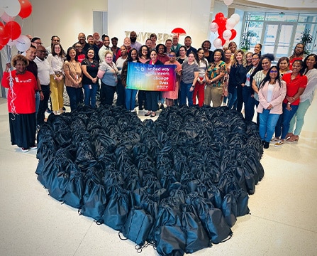 group photo with a heart made of black bags