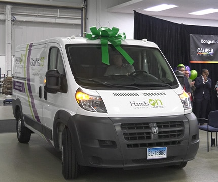 white van with a gift bow on top